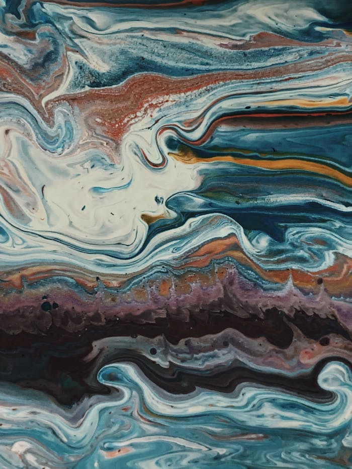 The Art of Drawing Readers In: Your attractive post title goes here Colorful abstract fluid painting with dynamic swirls in blues, reds, and whites.